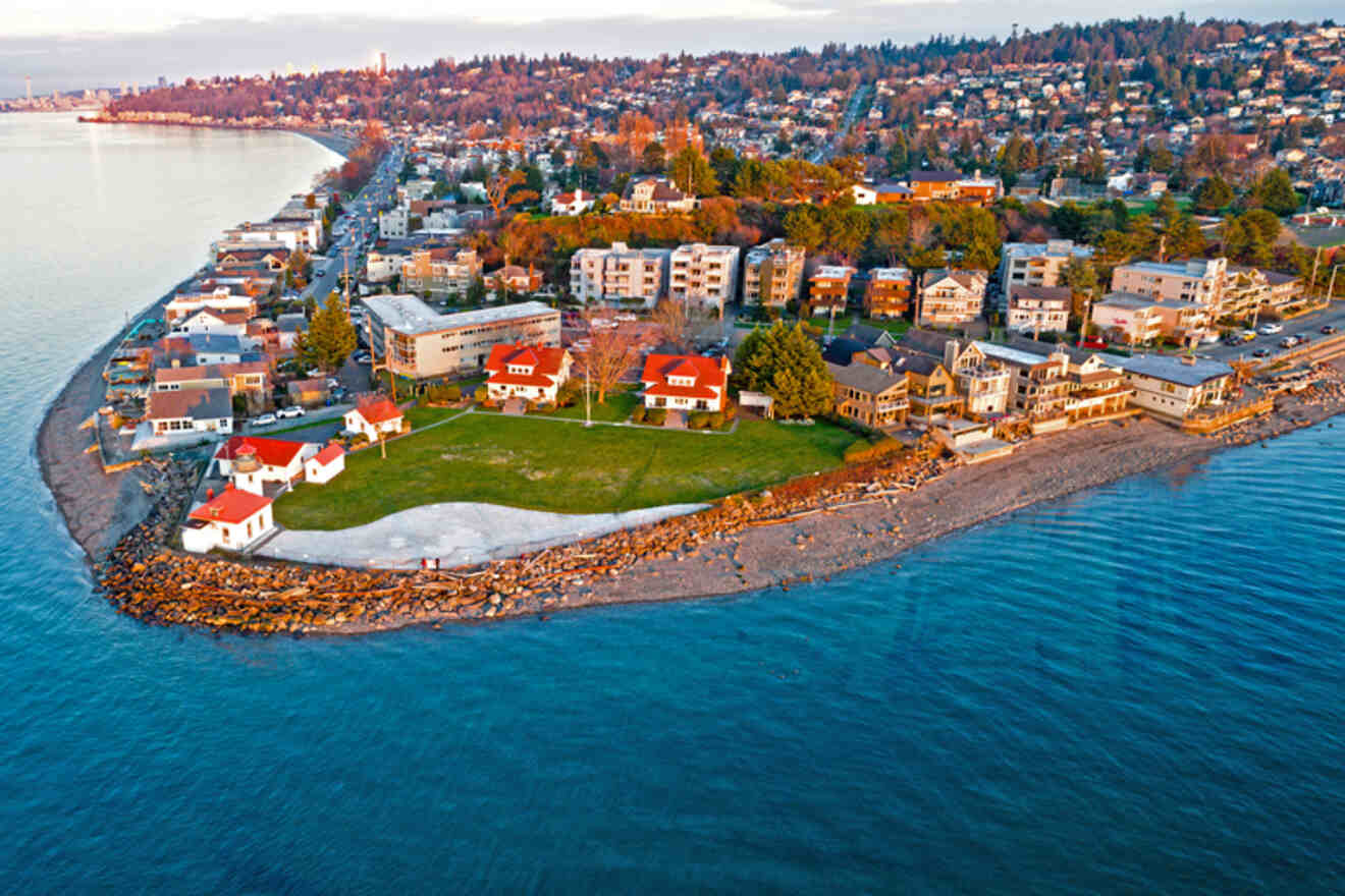 Sunset view of West Seattle's shoreline, featuring the quaint Alki Point Lighthouse and beachfront homes