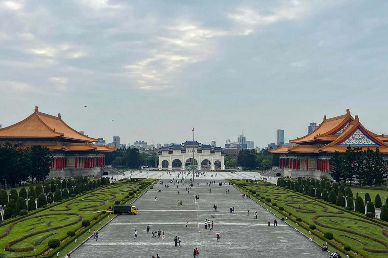 The grand, symmetrical landscape of Liberty Square with the National Theater and Concert Hall framing the Chiang Kai-shek Memorial Hall against a clear sky.