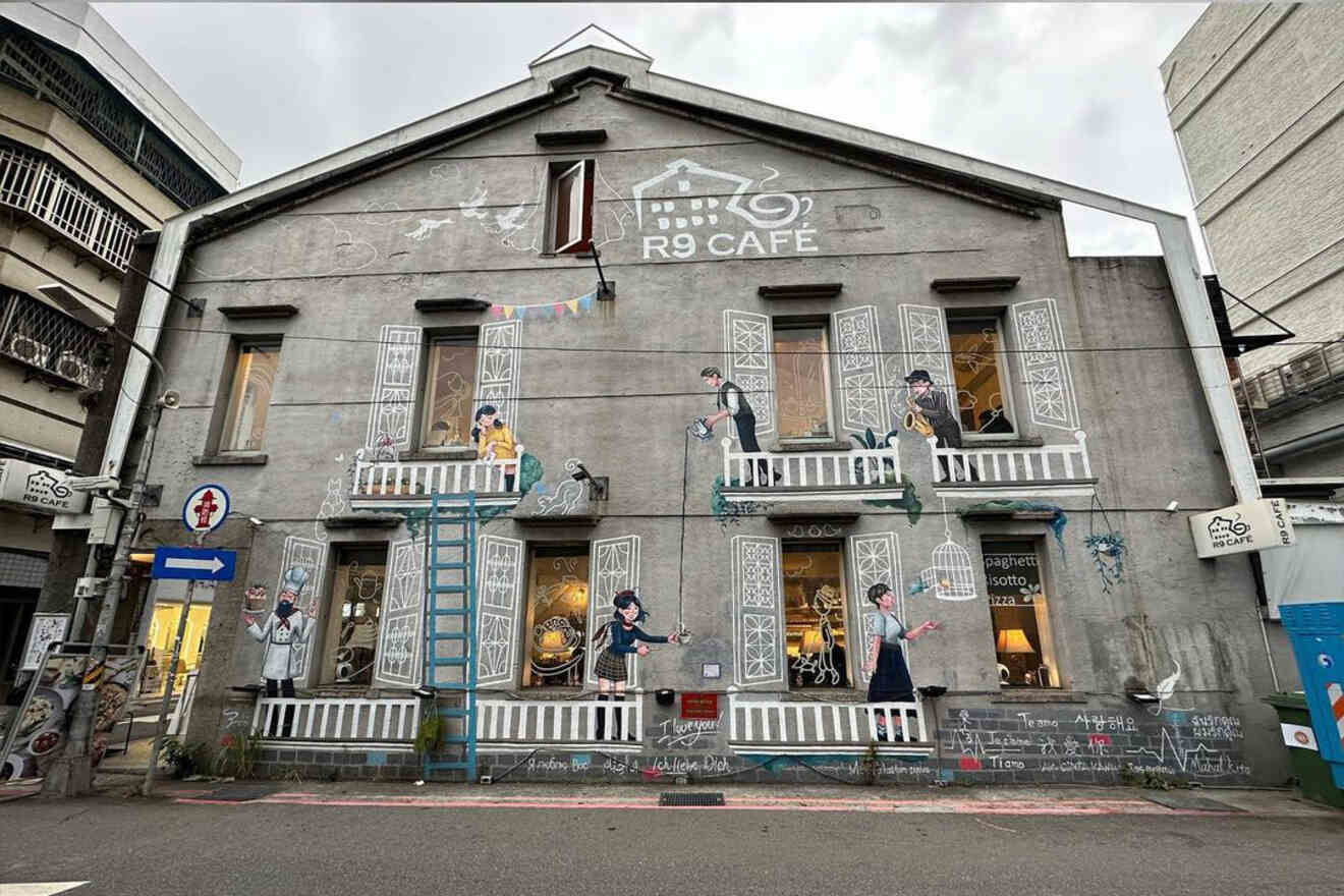 The charming facade of R9 Cafe in Zhongshan district, adorned with artistic murals and whimsical figures that evoke a creative urban atmosphere.