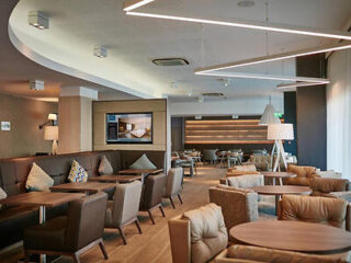 Contemporary hotel lounge with plush seating, designer lighting, and modern décor