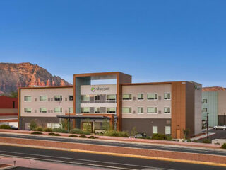 Exterior of Element Sedona hotel showcasing a contemporary design with a clear view of the red rock mountains