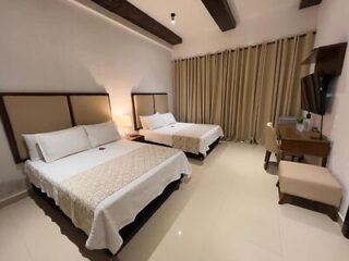 Spacious hotel room with two single beds, contemporary decor, and a neutral color palette