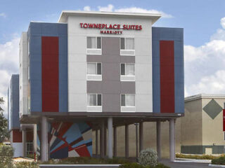 Front view of TownePlace Suites by Marriott, with its unique elevated design and colorful geometric art under the overhang