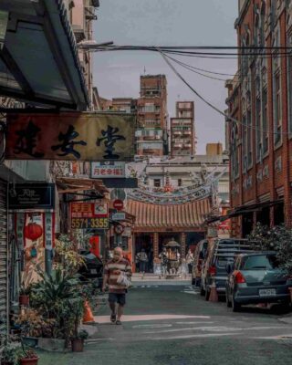 A traditional street scene in Datong district, where old Taipei charm is preserved among historic shopfronts and a temple gateway.