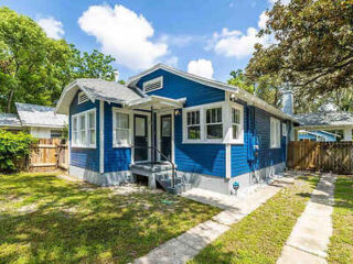 Charming blue-painted bungalow-style house with white trim and a cozy front porch