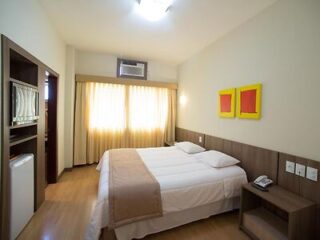 Entremares Hotel room with a comfortable double bed, soft lighting, and contemporary wooden furnishings