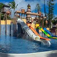 Children's water playground with slides and pirate-themed structures at the Princess Family Club Bavaro resort.