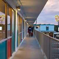 Evening view on the balcony of The Thunderbird Inn with a guest enjoying the vintage Americana hotel vibe.
