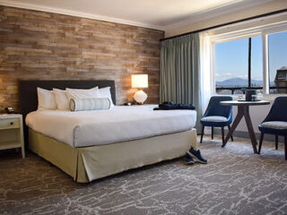 Luxurious Beachside Inn room with a plush king-size bed and a scenic window view.