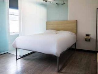 Minimalist bedroom with a simple platform bed, clean lines, and a muted color palette creating a modern aesthetic.