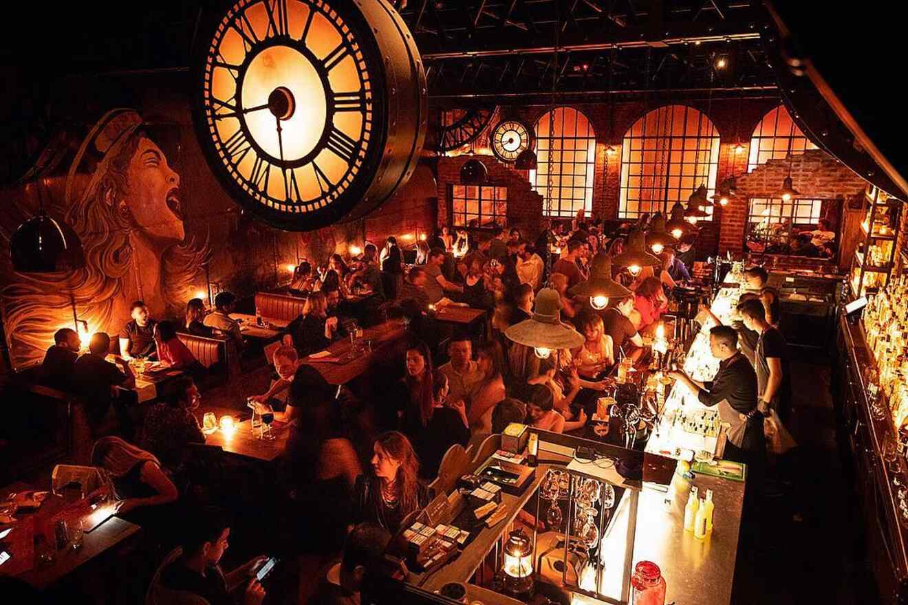A warm and inviting ambience at J.W. Bradley LTD, featuring a large clock as the central art piece, with patrons enjoying their evening in a setting reminiscent of a classic speakeasy