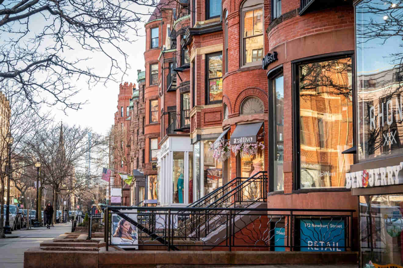 Street-level view of Newbury Street in Boston, highlighting the quaint charm of the brick buildings, boutique storefronts, and leafless winter trees