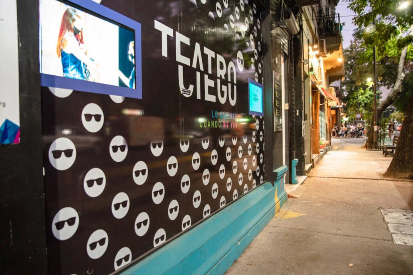 The dynamic exterior of Teatro Ciego in Buenos Aires, featuring a bold design with repeated patterns of sunglasses and the theater's slogan
