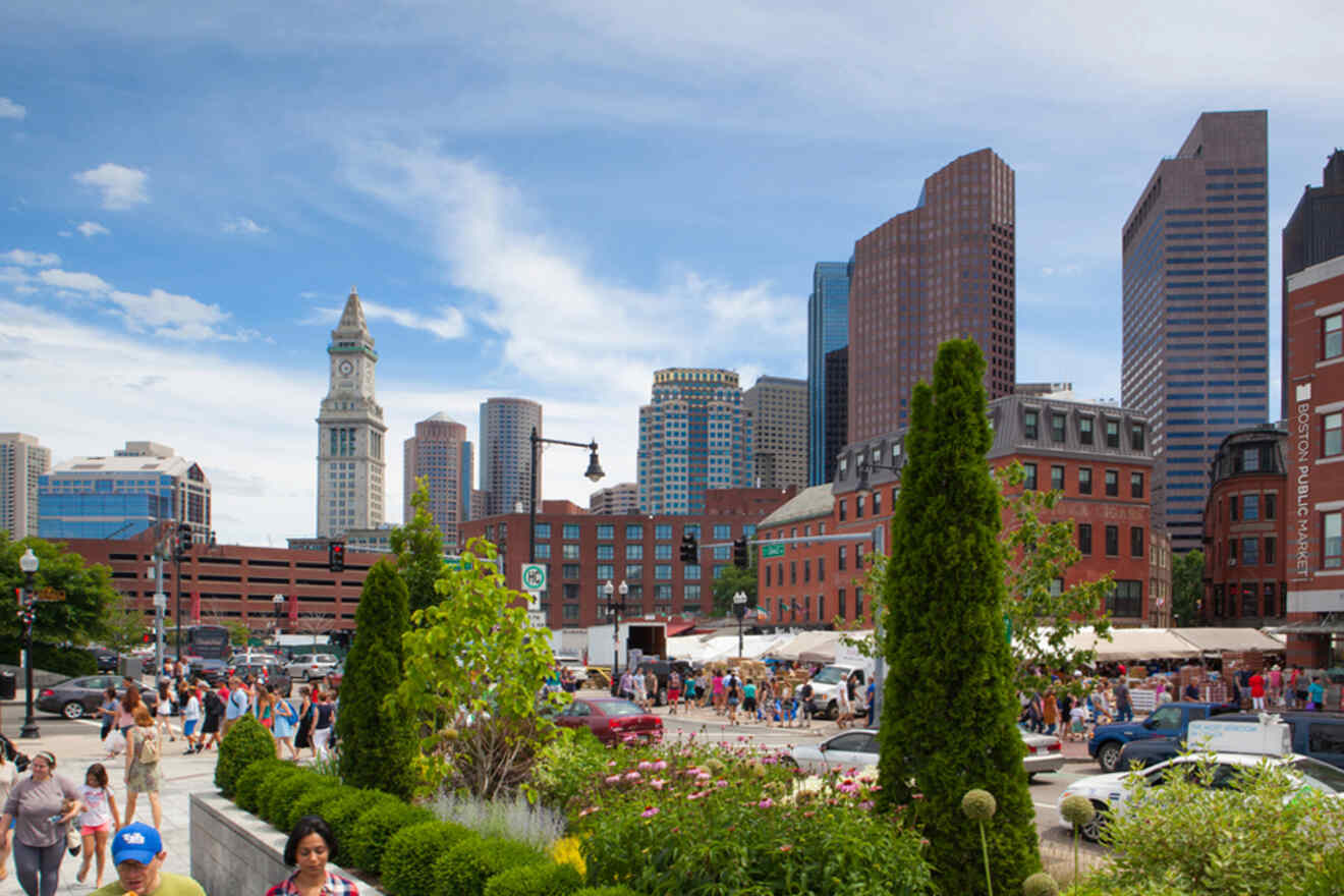Vibrant scene at the Rose Kennedy Greenway in Boston with crowds of people, food carts, and a view of the city's diverse architecture and lush landscaping