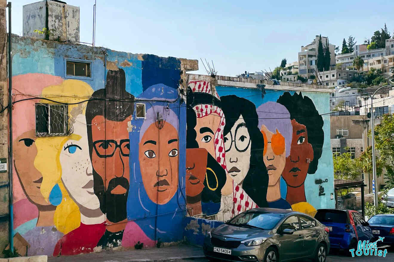 A colorful mural in the Jabal Al-Weibdeh neighborhood of Amman, Jordan, depicting diverse faces and expressions