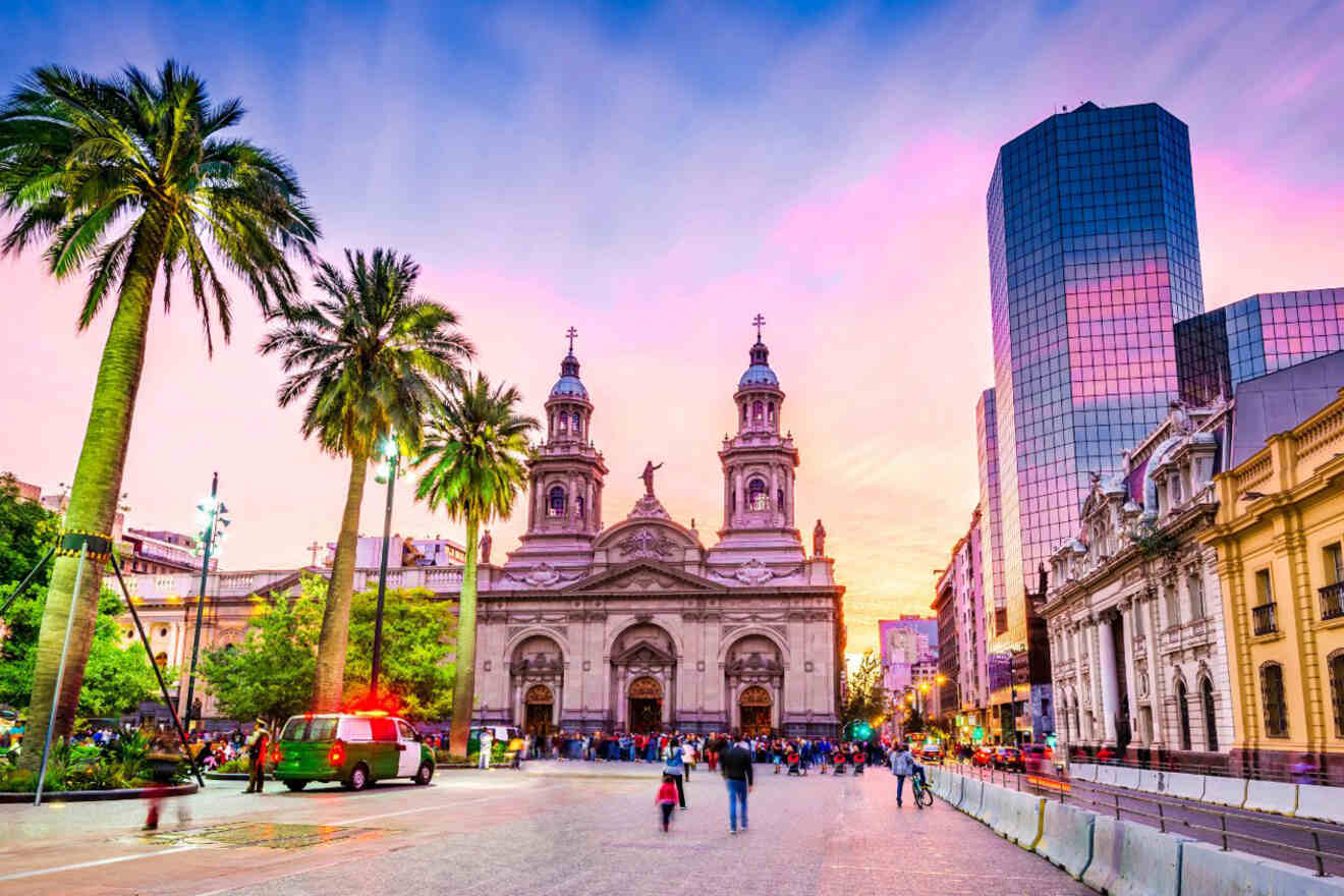 Plaza de Armas in Santiago, Chile, at dusk, featuring the Metropolitan Cathedral and surrounding palm trees against a vibrant sunset sky
