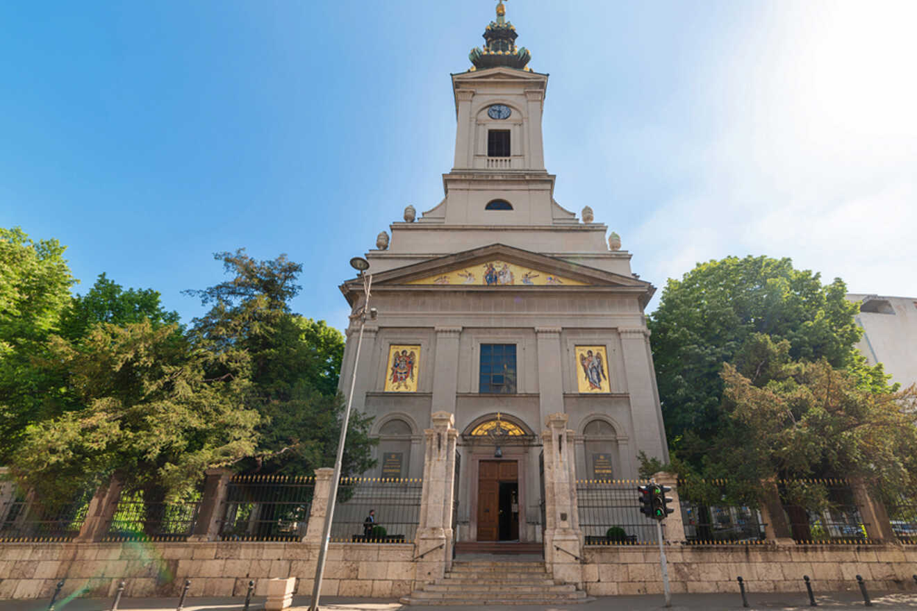 Facade of the Holy Archangel Michael Church in Belgrade, with its classical architecture featuring a bell tower and religious icons above the entrance
