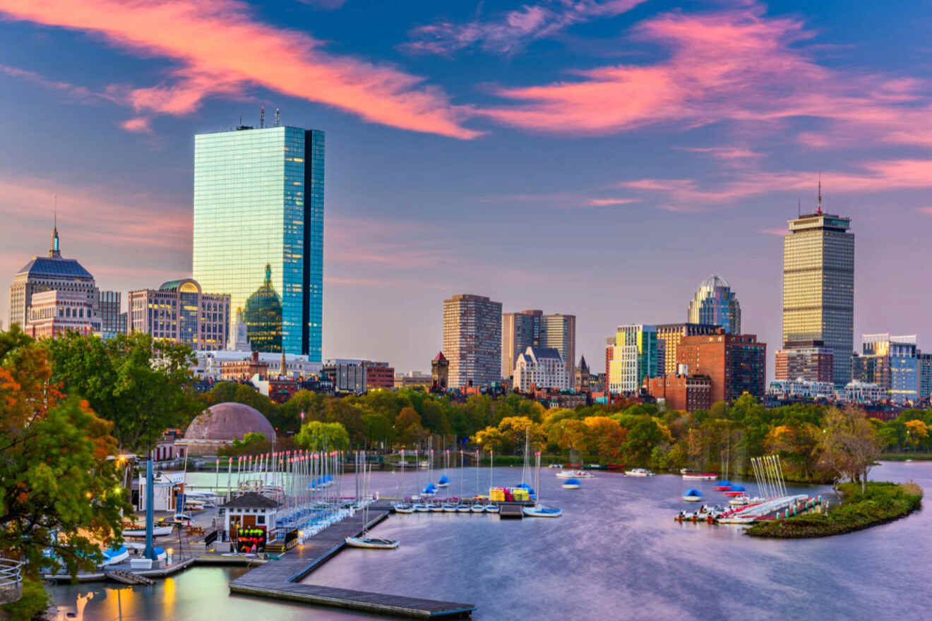 Twilight view of the Charles River Esplanade in Boston with the city skyline illuminated, showcasing the Hancock Tower and the golden dome of the Massachusetts State House