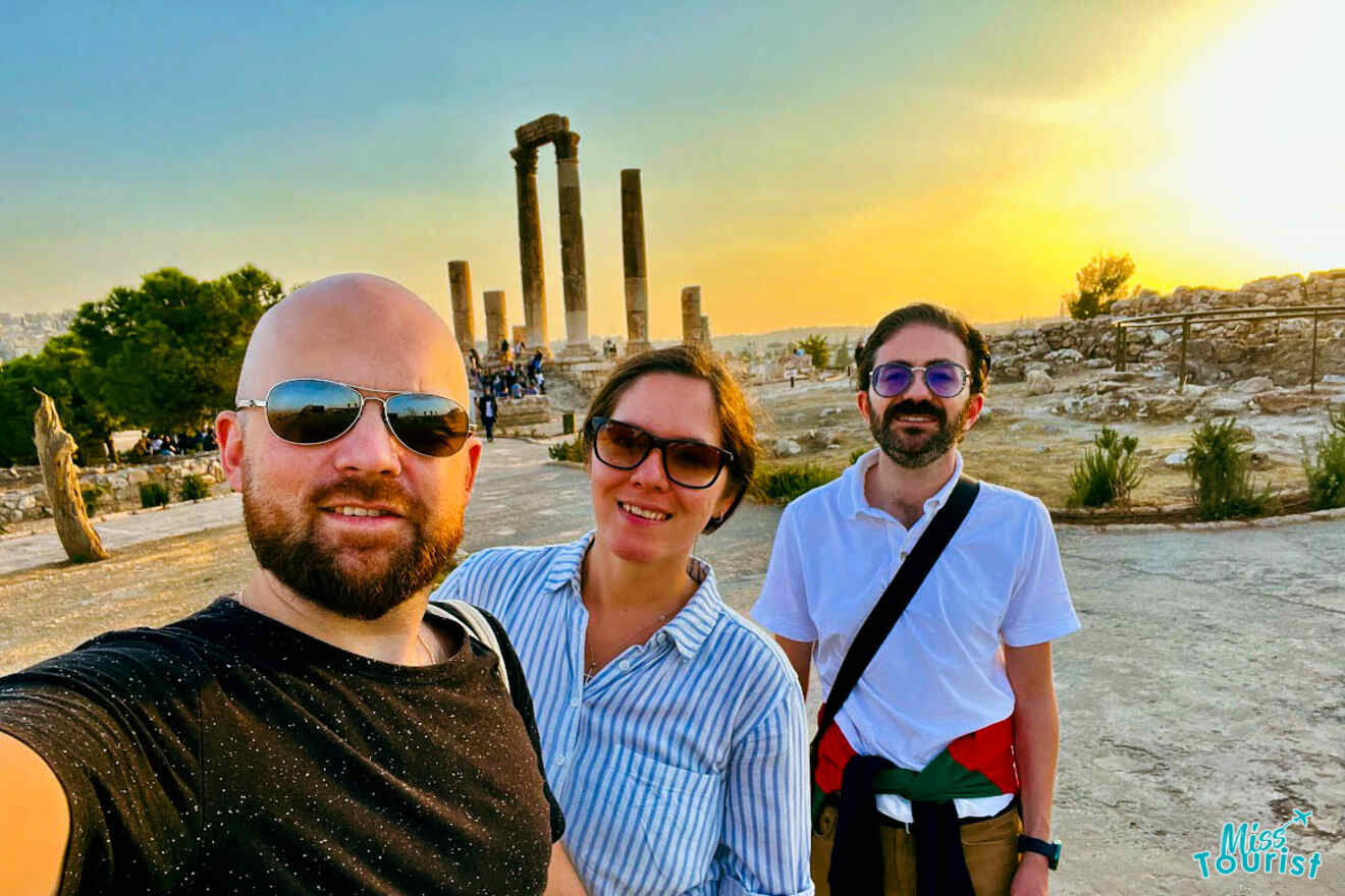 A group selfie of the writer of the post and friends at sunset with the Amman Citadel ruins in the background, capturing the shared experience of exploring the city's ancient heritage