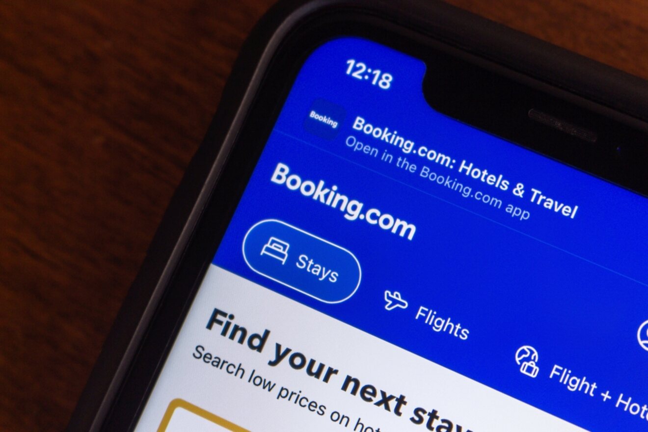 Smartphone displaying the Booking.com header for 'Hotels & Travel' with navigation tabs for 'Stays', 'Flights', and 'Flight + Hotel', emphasizing the ease of searching for travel deals directly from the Booking.com app on a mobile device
