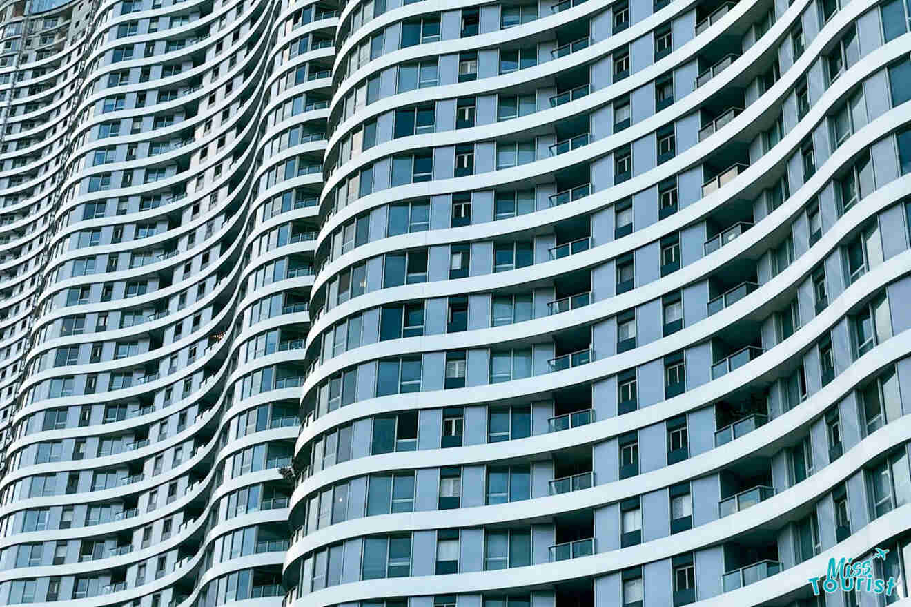 Close-up of the curvilinear architecture of a modern high-rise building in Tel Aviv, showcasing the intricate design and balconies