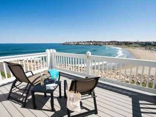 Breathtaking ocean view from a deck with outdoor chairs, offering a serene spot to enjoy the coastal beauty and soothing sea breeze.