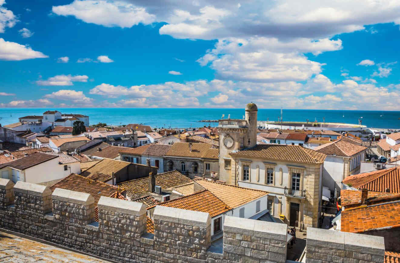 Rooftop view over Saintes-Maries-de-la-Mer, France, with the Mediterranean Sea in the distance and a clear blue sky overhead