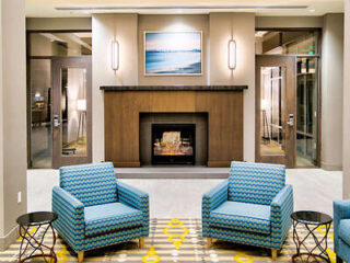 Elegant lobby area of Best Western with patterned chairs and a welcoming fireplace