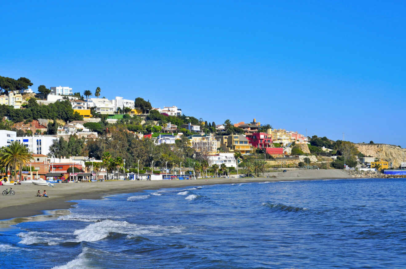Tranquil shores of El Palo, Málaga, with a view of beach-goers and coastal residences