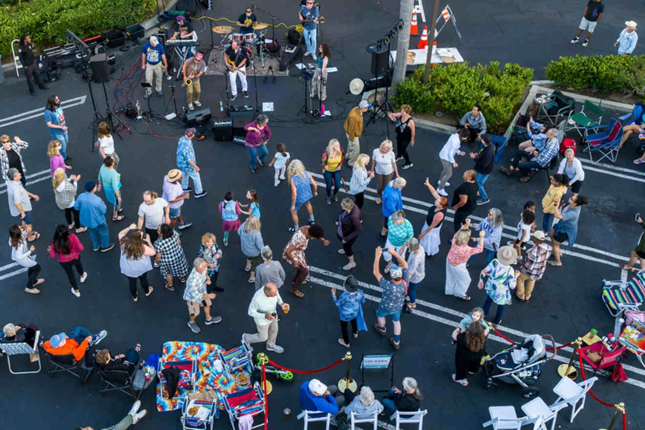 A relaxed gathering of artists, dancers and spectators in a parking lot in Bixby Knolls, Long Beach