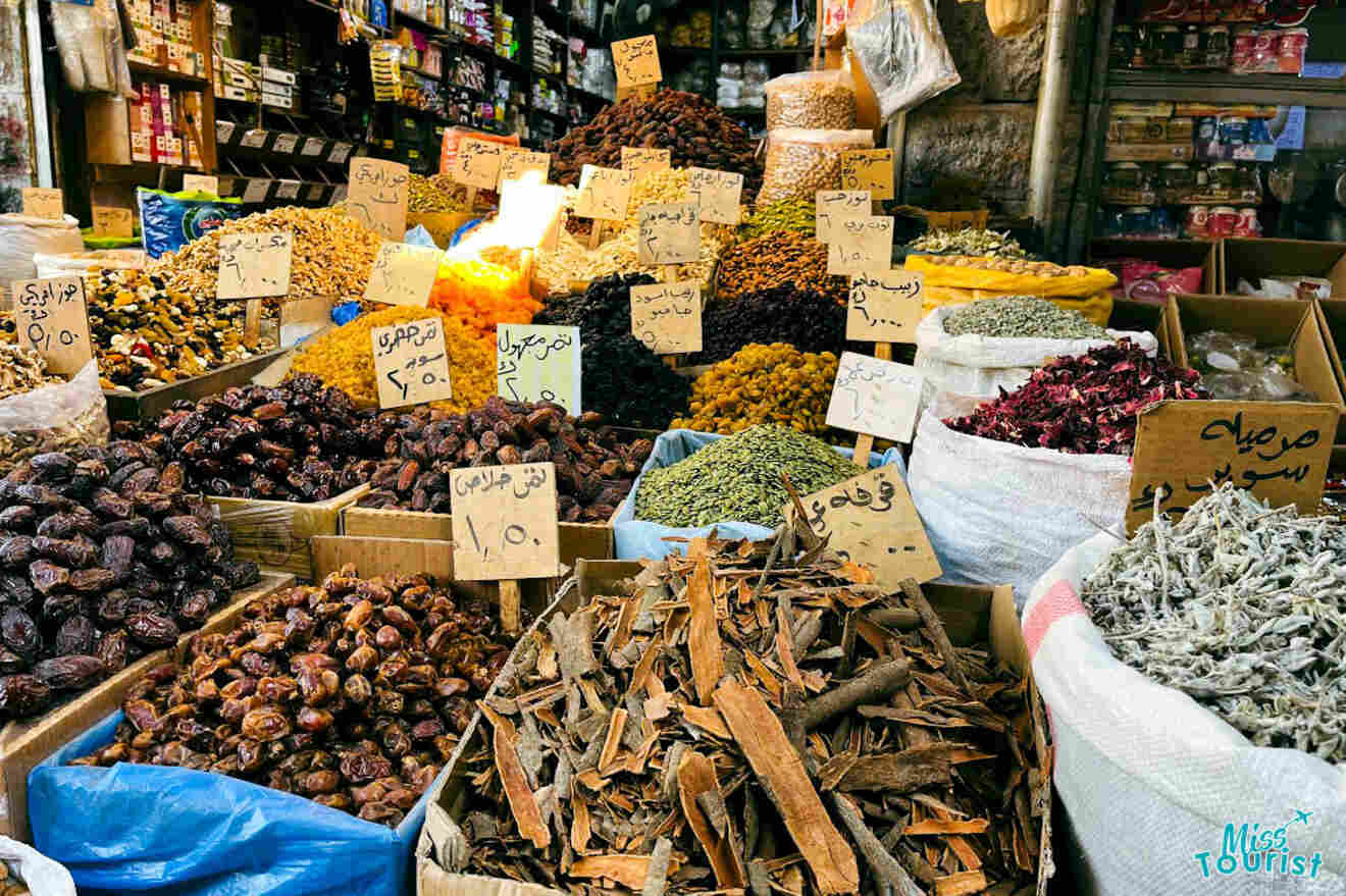 A vibrant display of various dried fruits, nuts, and spices at a bustling souk in Amman, Jordan