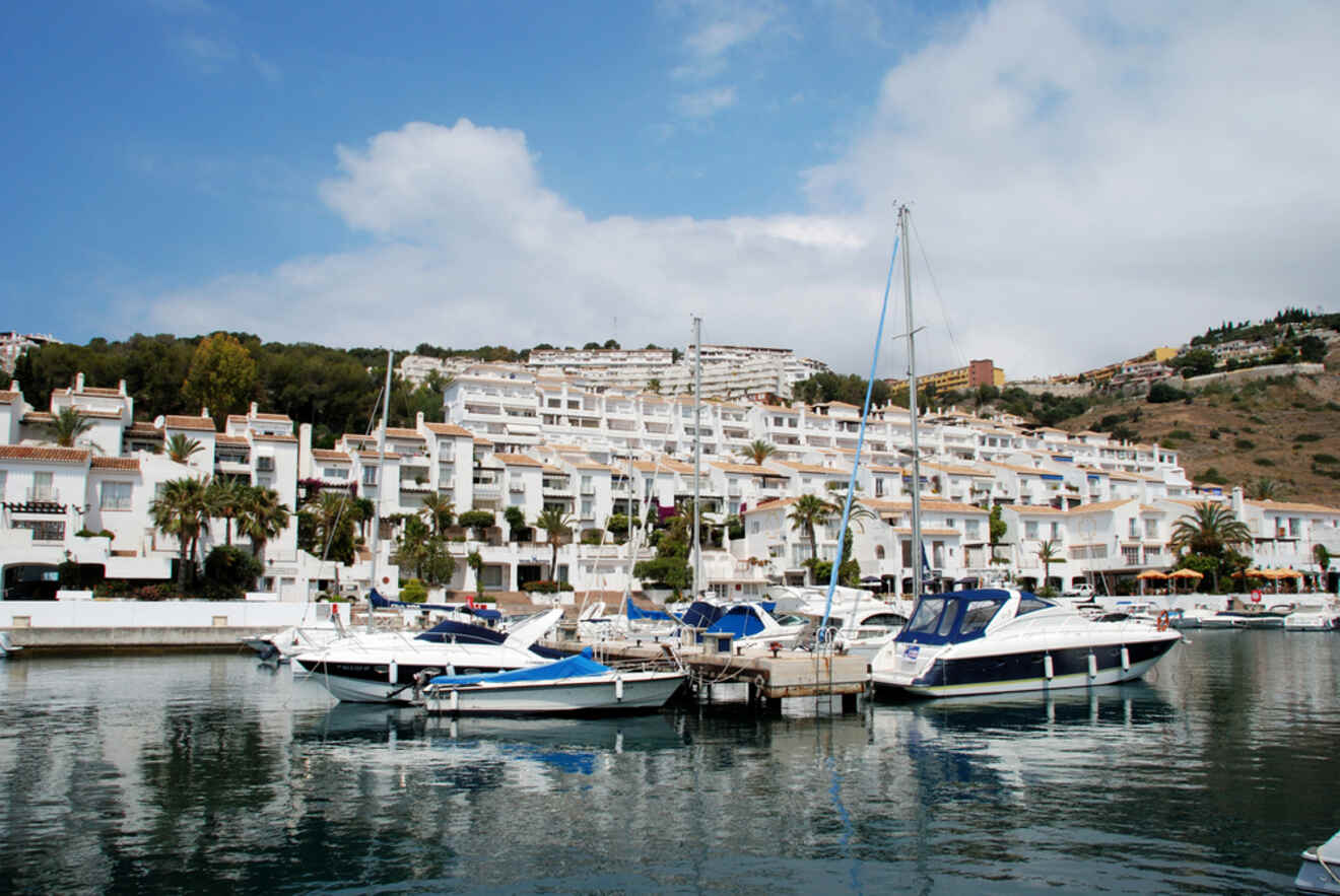 Serene marina at Eastern Coast, Málaga, with white buildings and moored boats reflecting the leisurely coastal lifestyle