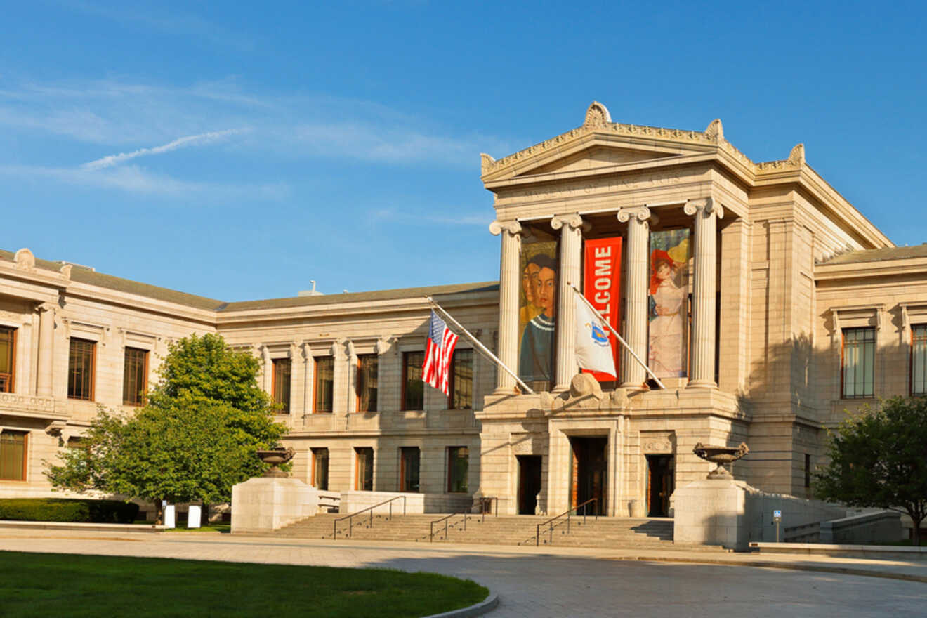 Facade of the Museum of Fine Arts in Boston with American flags, large welcoming banners, and a classical architectural design