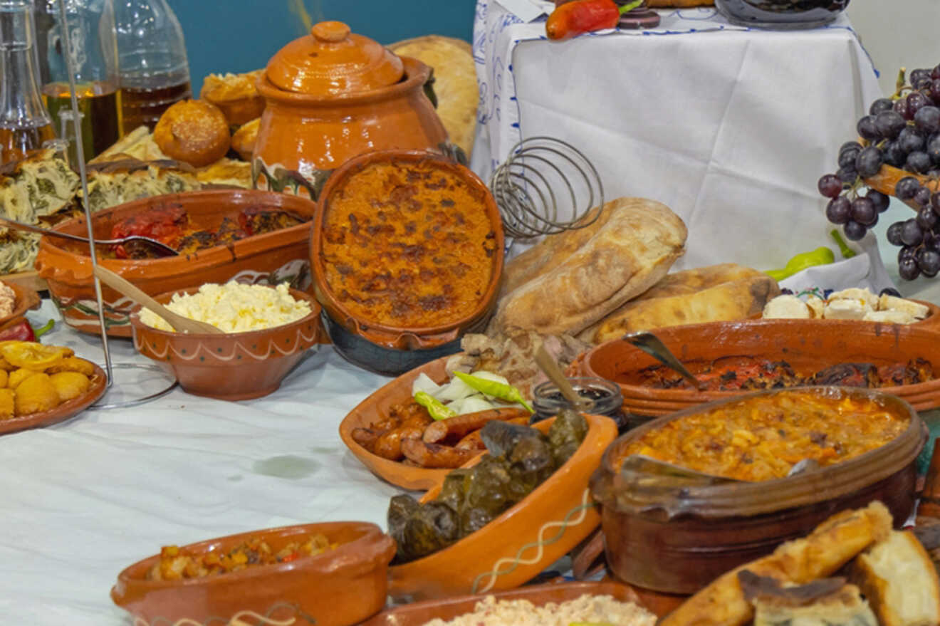 A close-up of traditional Serbian dishes, highlighting the country’s rich cuisine with various specialties in clay pots and fresh bread