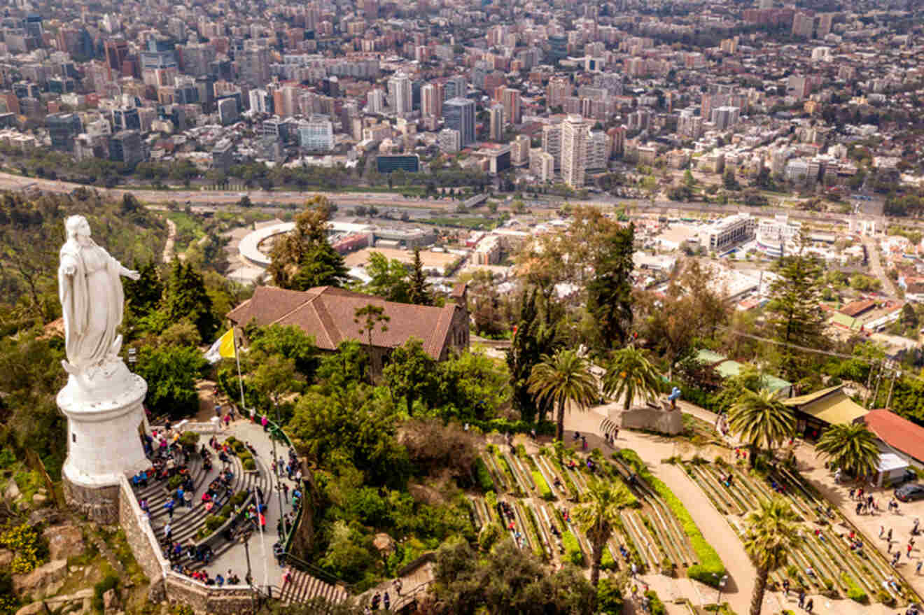 Aerial view of the statue of the Virgin Mary overlooking the bustling cityscape from Metropolitan Park, Santiago, Chile