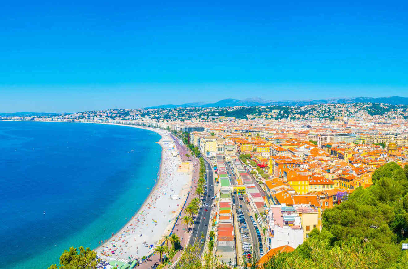 Panoramic view of Nice, France, with the famous Promenade des Anglais along the Baie des Anges and a bustling beach scene