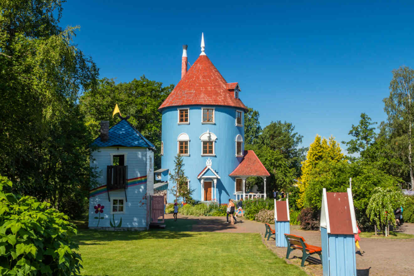 The whimsical towers and colorful façades of Moomin World in Naantali, near Turku, under a bright blue summer sky