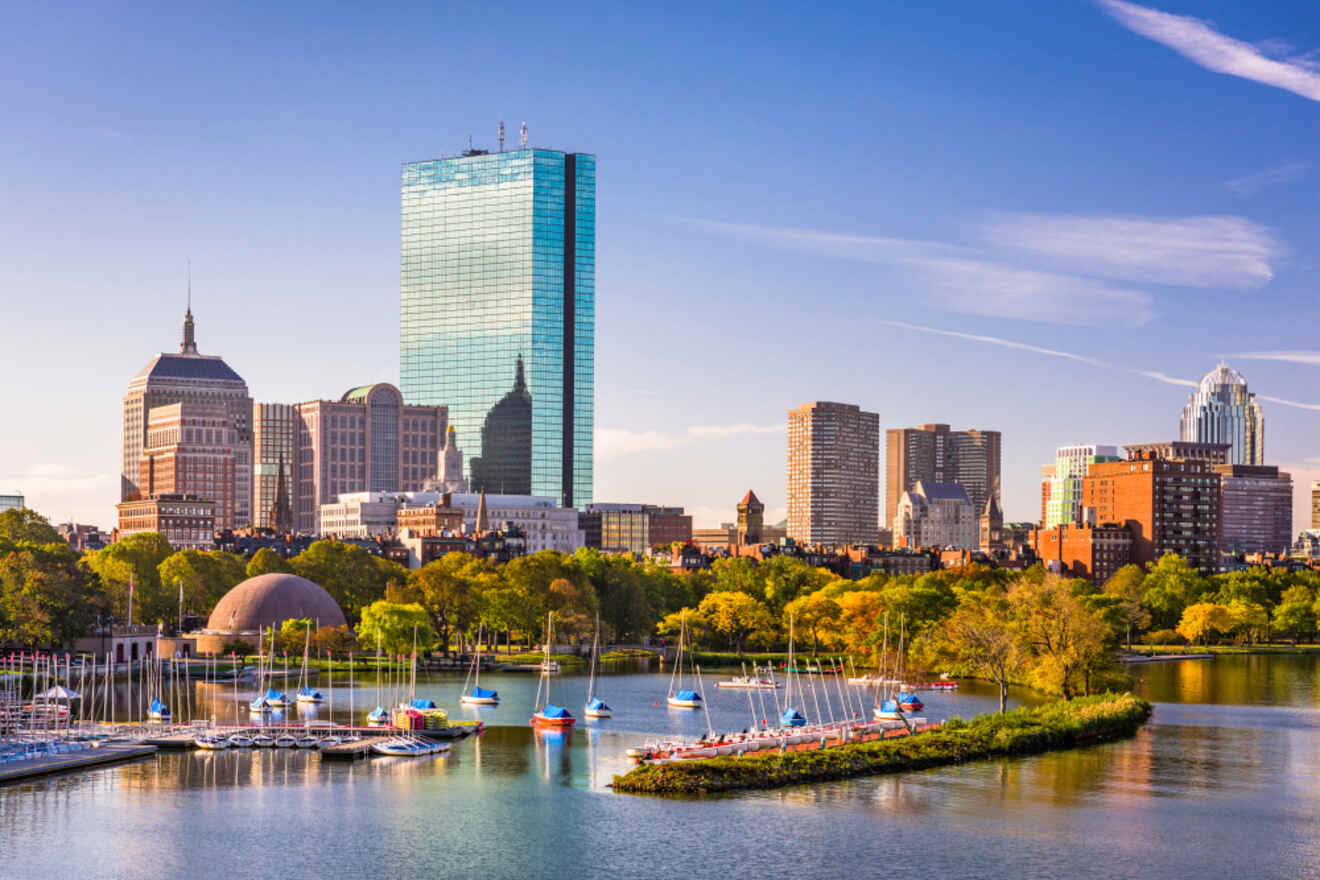 A serene view of Boston's skyline, featuring the John Hancock Tower and a bustling Charles River filled with sailboats, against a clear blue sky