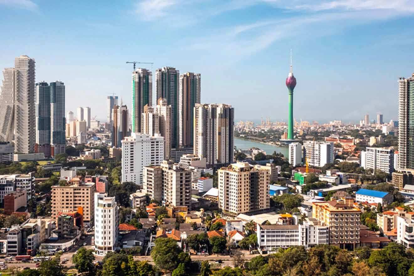 A panoramic view of Colombo’s skyline, showcasing a blend of modern high-rise buildings and lush green spaces, with the iconic Lotus Tower standing out against the clear sky.