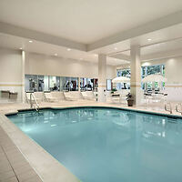 Indoor pool at Hilton Garden Inn with a spacious, well-lit pool area, loungers, and large windows for a relaxing ambiance