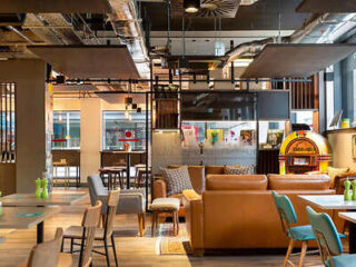 Casual hotel restaurant with eclectic seating and bright decor.