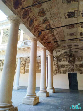 The historic ceiling frescoes and stately columns of Padua University's grand hall, representing the rich academic legacy