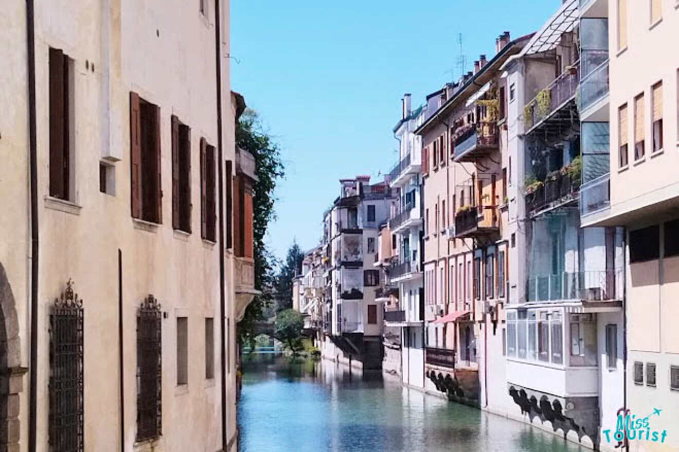 Charming view of Padua's navigable waterways, with colorful buildings mirrored in the still canal