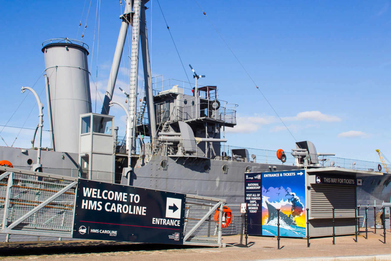 HMS Caroline in Belfast, a historic naval ship turned museum, under a clear blue sky.