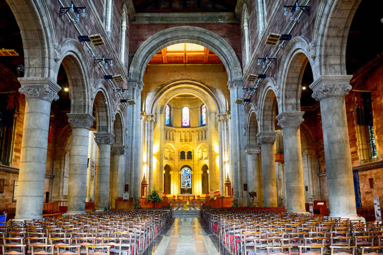 Interior of St. Anne's Cathedral in Belfast, showing the nave, arched ceilings, and rows of seating.