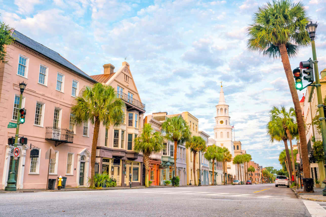 A serene morning scene in downtown Charleston, with historic pastel-colored buildings, palm trees lining the street, and the distinctive St. Michael's Church spire in the distance