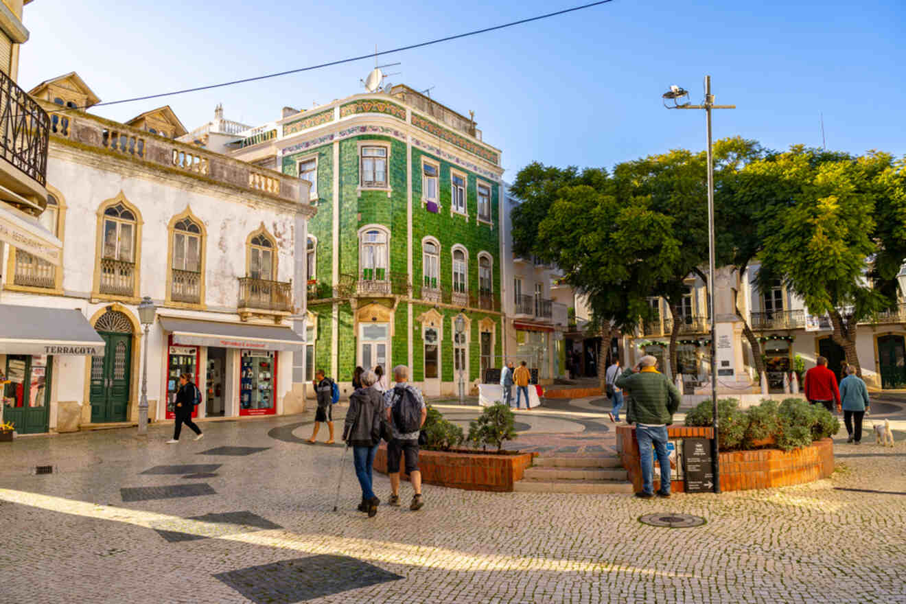 Historic Lagos town center with cobblestone streets and colorful, traditional Portuguese buildings, bustling with pedestrians and casual shoppers