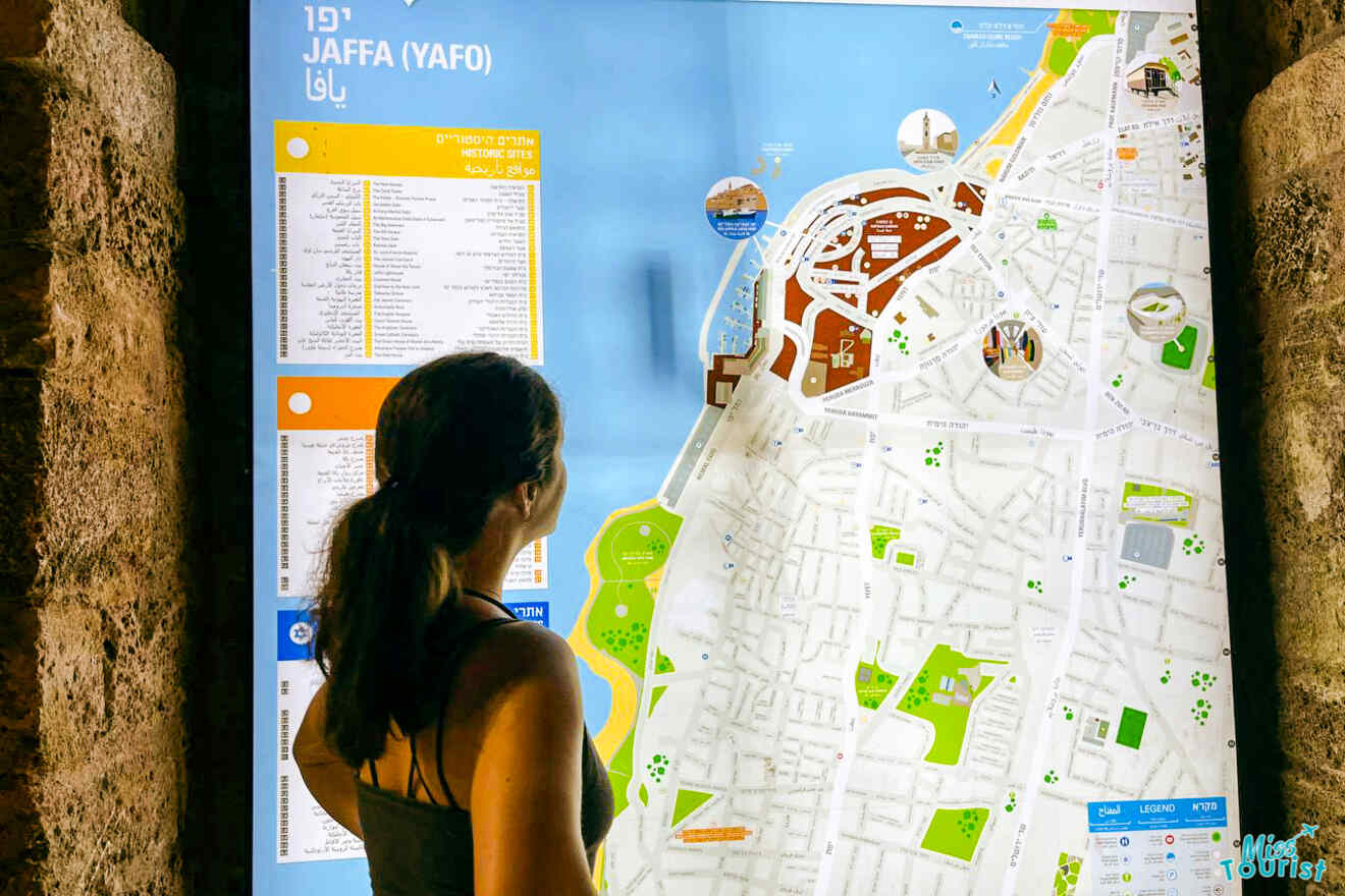 The post's author studies an illuminated map of Jaffa (Yafo), showcasing various points of interest and historical sites, with content in multiple languages for accessibility.