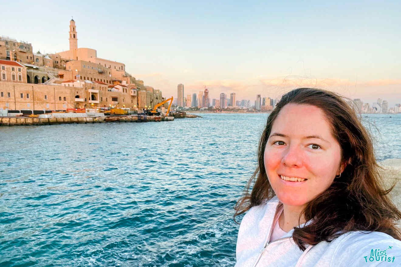 The author of the post taking in the serene view of the ancient Jaffa skyline against the backdrop of modern Tel Aviv at sunset