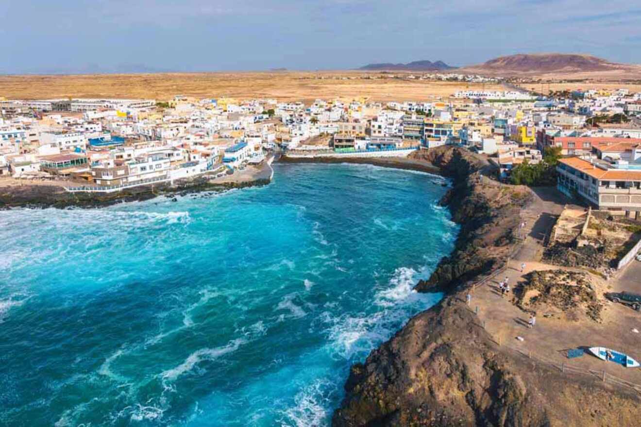 Panoramic view of El Cotillo in Fuerteventura, with rugged coastline, turquoise waters, and a quaint town with colorful buildings